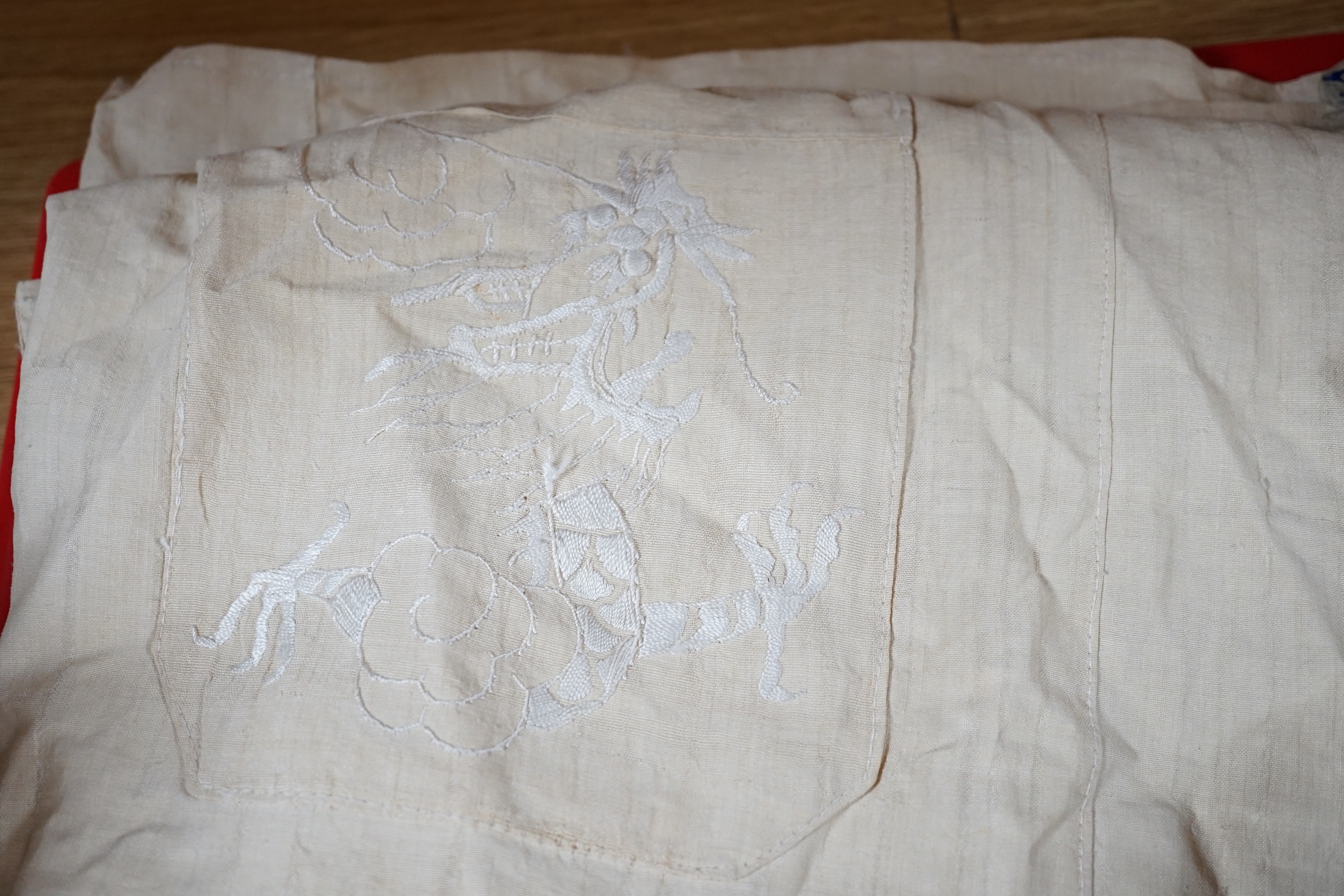 Two mid 20th century Chinese embroidered Rank Badges, a large gold thread dragon embroidered collar, three Chinese embroidered panels and a Japanese 1930’s Shantung silk dragon embroidered Kimono dressing gown